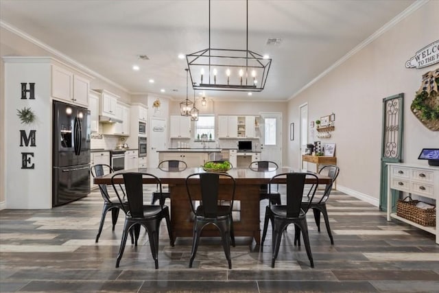 dining space featuring dark hardwood / wood-style floors and ornamental molding