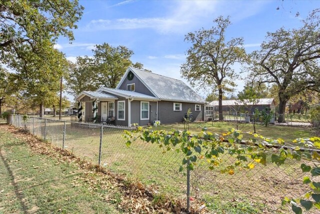 back of property featuring a yard