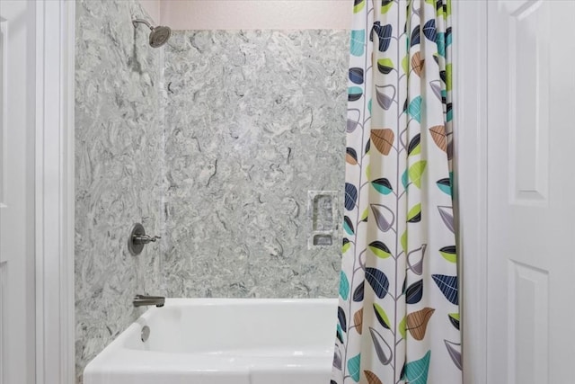 bathroom with shower / bath combo with shower curtain