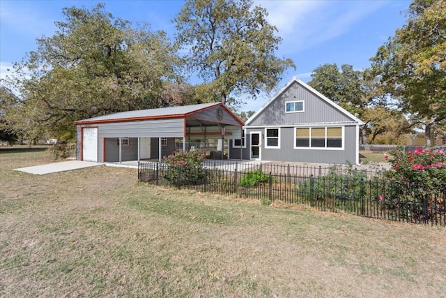 rear view of property featuring a carport and a lawn