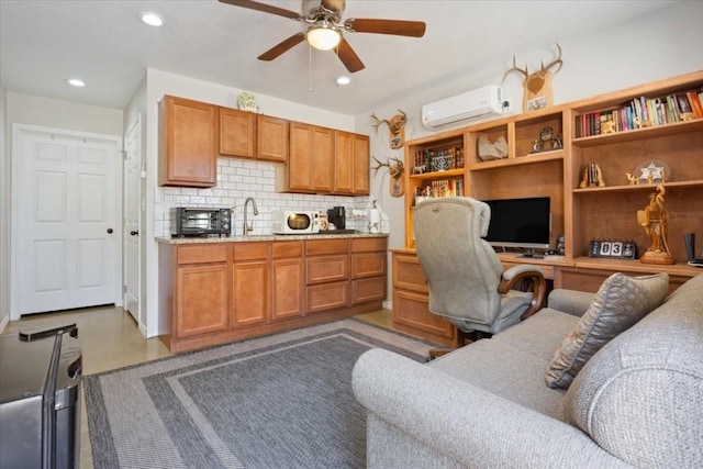 office featuring a wall unit AC, ceiling fan, and sink