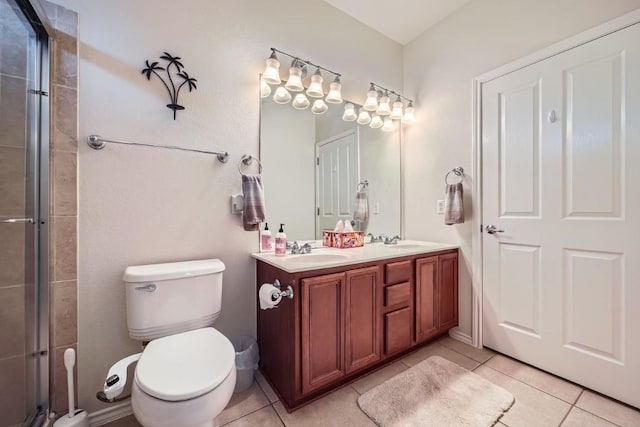 bathroom featuring tile patterned floors, vanity, toilet, and an enclosed shower