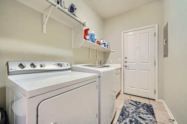 laundry room with cabinets, light tile patterned floors, electric panel, and independent washer and dryer