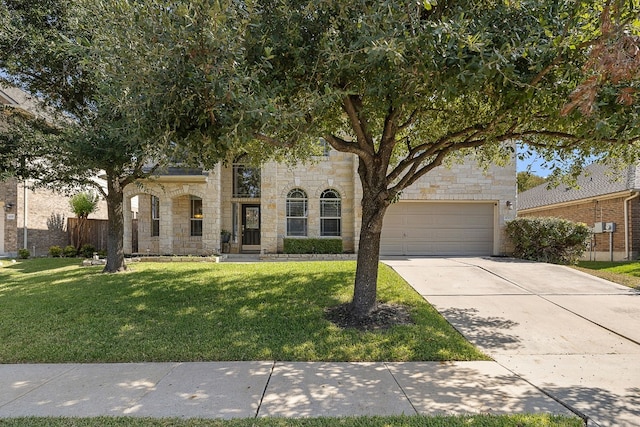 view of front of property with a garage and a front yard