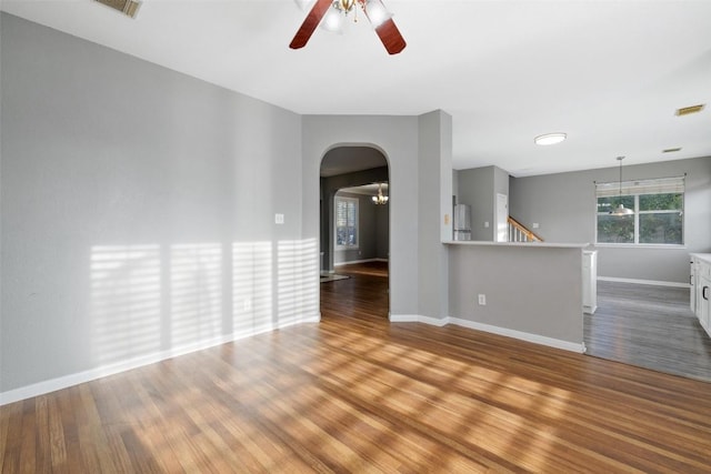 unfurnished living room featuring hardwood / wood-style flooring and ceiling fan