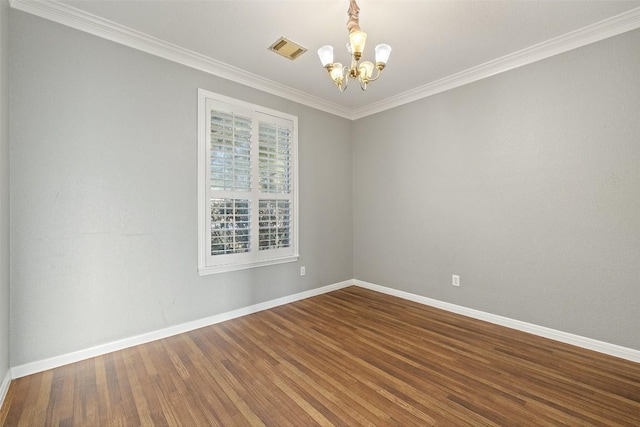 unfurnished room with hardwood / wood-style flooring, crown molding, and a chandelier