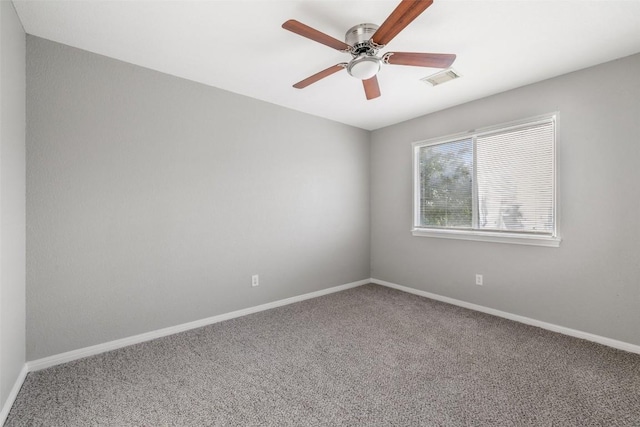 carpeted spare room with ceiling fan