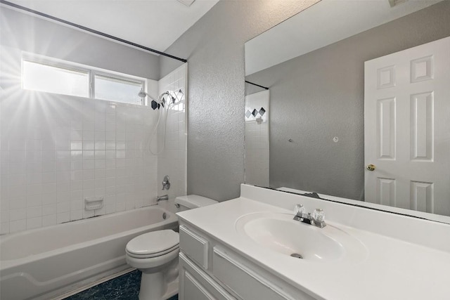 full bathroom featuring vanity, toilet, and tiled shower / bath