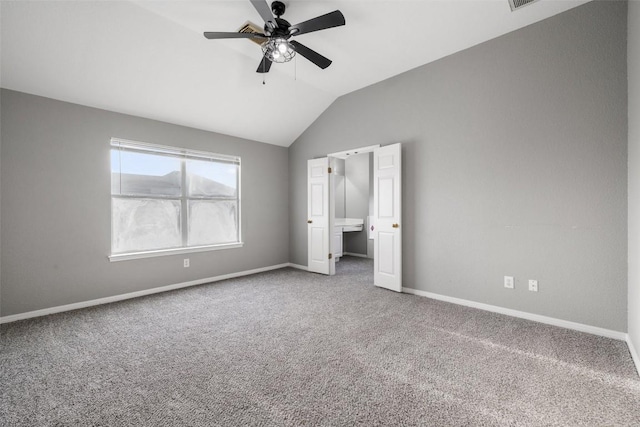 unfurnished bedroom with ceiling fan, carpet, and vaulted ceiling