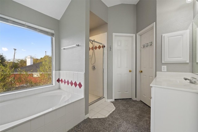 bathroom featuring separate shower and tub, vanity, a healthy amount of sunlight, and vaulted ceiling