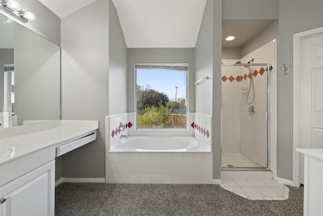 bathroom featuring shower with separate bathtub and vanity