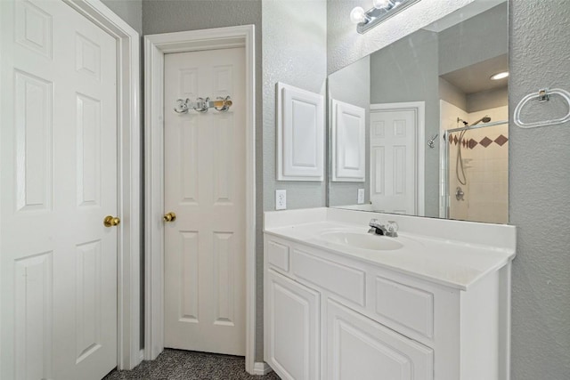 bathroom featuring vanity and a tile shower