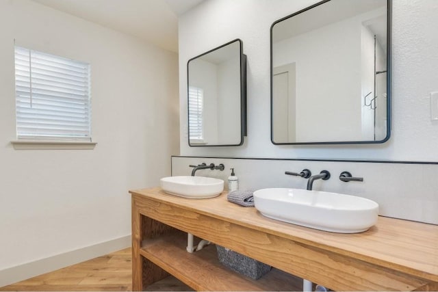 bathroom featuring wood-type flooring, vanity, and plenty of natural light