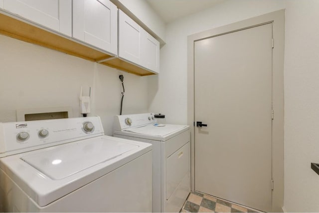 clothes washing area with cabinets and washing machine and dryer