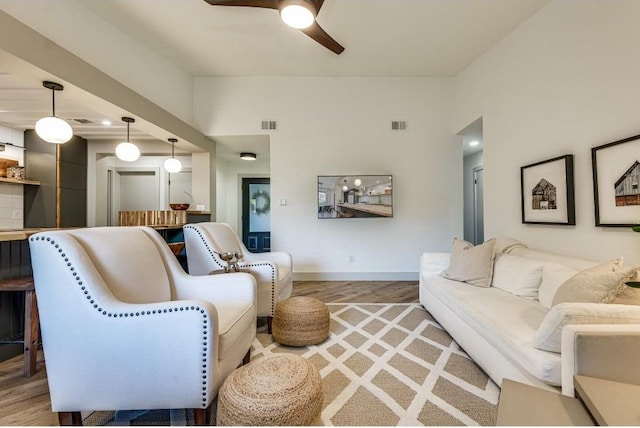 living room featuring ceiling fan and wood-type flooring