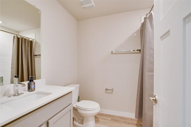 bathroom featuring hardwood / wood-style flooring, vanity, and toilet