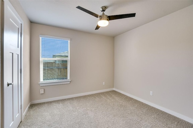 spare room with carpet floors and ceiling fan