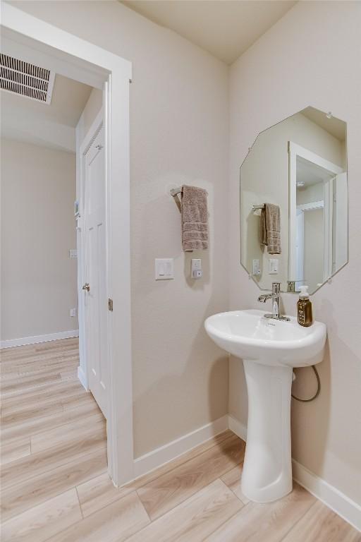 bathroom with hardwood / wood-style floors