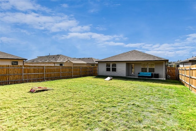 back of house featuring a lawn and an outdoor hangout area