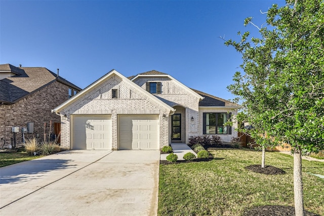 view of front of property with a garage and a front lawn