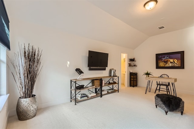 living area with carpet and lofted ceiling