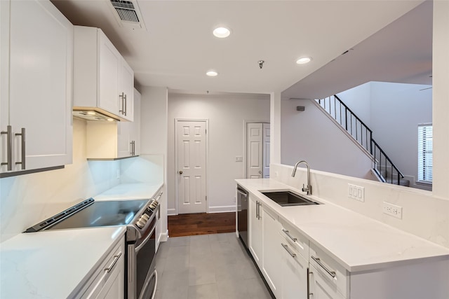 kitchen featuring white cabinets, appliances with stainless steel finishes, and sink