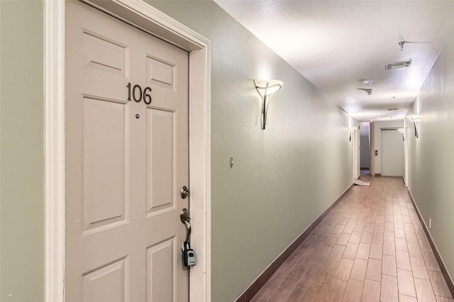 hall with hardwood / wood-style flooring