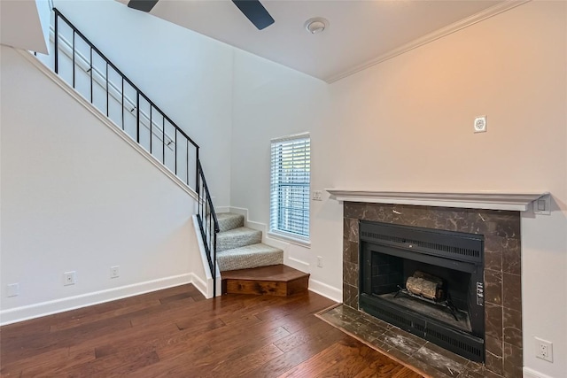 unfurnished living room with ornamental molding, hardwood / wood-style floors, and a fireplace