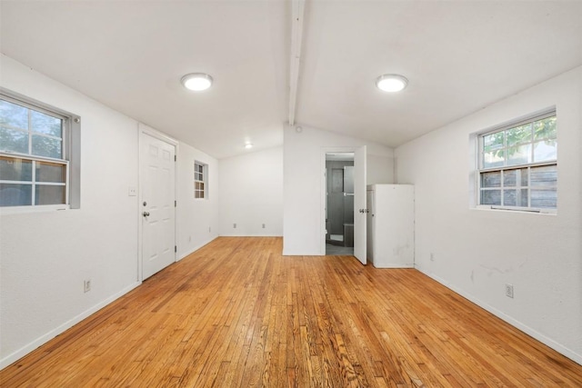 interior space featuring baseboards and light wood finished floors