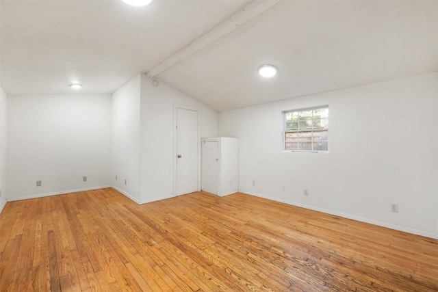 below grade area with baseboards and light wood finished floors