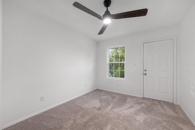 empty room featuring ceiling fan and carpet floors