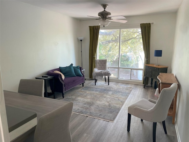 living room with ceiling fan and light hardwood / wood-style floors