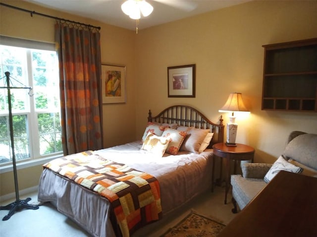 bedroom featuring ceiling fan and light carpet