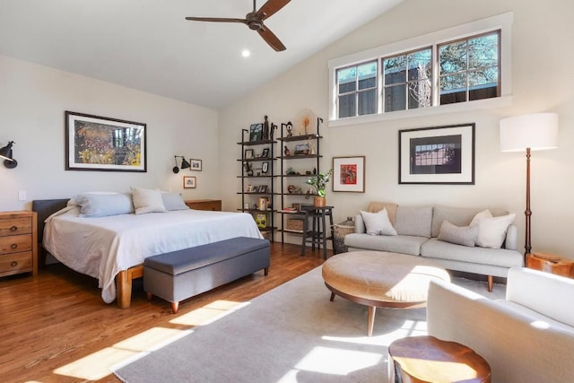 bedroom featuring hardwood / wood-style floors, high vaulted ceiling, and ceiling fan