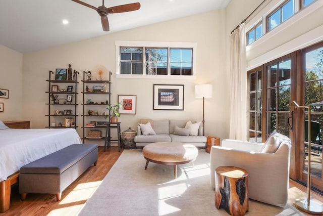 bedroom with high vaulted ceiling and light wood-type flooring