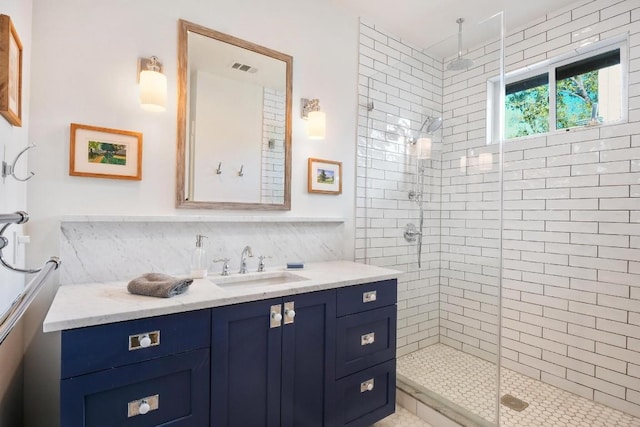 bathroom with vanity, backsplash, and a shower with shower door