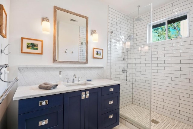 full bath featuring backsplash, vanity, visible vents, and a stall shower