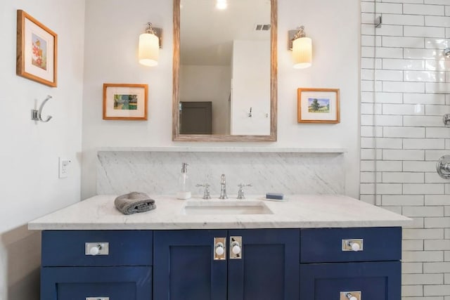 bathroom with vanity and decorative backsplash