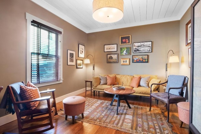 living area featuring wood ceiling, ornamental molding, and hardwood / wood-style floors