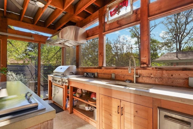sunroom with a sink and plenty of natural light