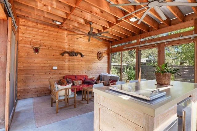 unfurnished sunroom featuring ceiling fan and beverage cooler