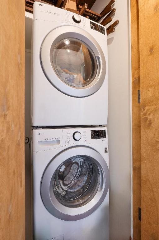 laundry area featuring stacked washer / dryer