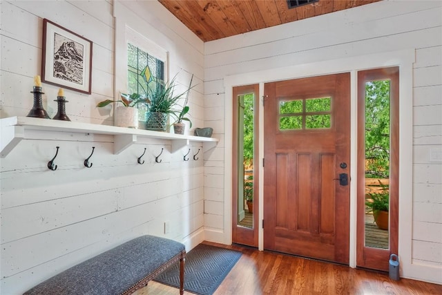 mudroom with wood finished floors, a healthy amount of sunlight, wood walls, and wooden ceiling