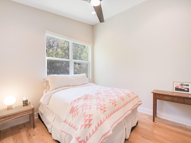 bedroom with light hardwood / wood-style floors and ceiling fan