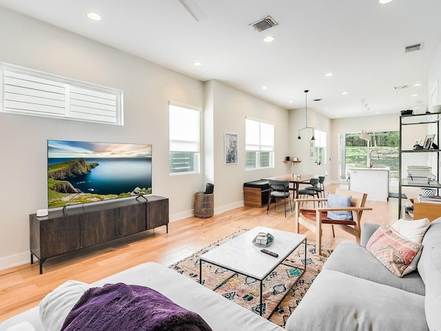 living room with sink and light hardwood / wood-style flooring