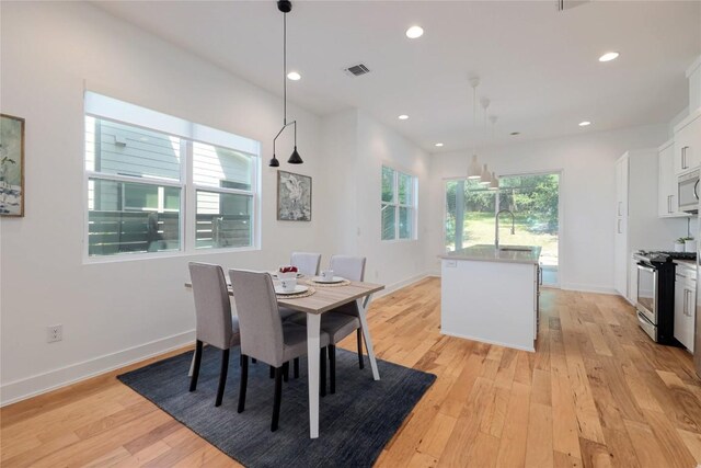 1211 Cometa St Unit B, Austin, TX 78721 - dining room featuring light wood-style flooring, baseboards, and recessed lighting