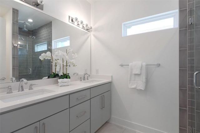 1211 Cometa St Unit B, Austin, TX 78721 - bathroom with double vanity, a stall shower, baseboards, and tile patterned flooring
