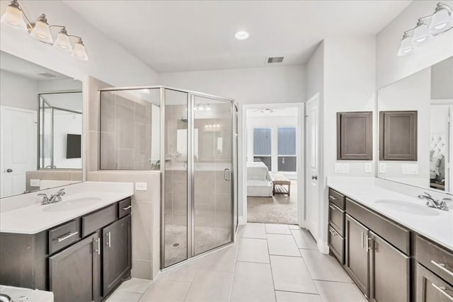 bathroom featuring walk in shower, vanity, tile patterned flooring, and ceiling fan