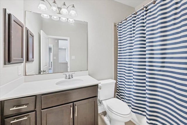 bathroom featuring toilet, walk in shower, and vanity