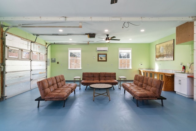 interior space featuring a garage door opener, a wall unit AC, ceiling fan, and sink